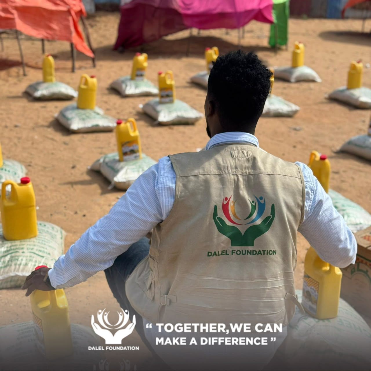 A Dalel Foundation field worker in a branded vest preparing rice sacks and cooking oil for distribution to families